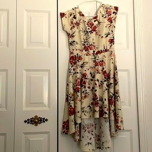 Beige flower dress. Short front mid length on the back. It is in excellent terms